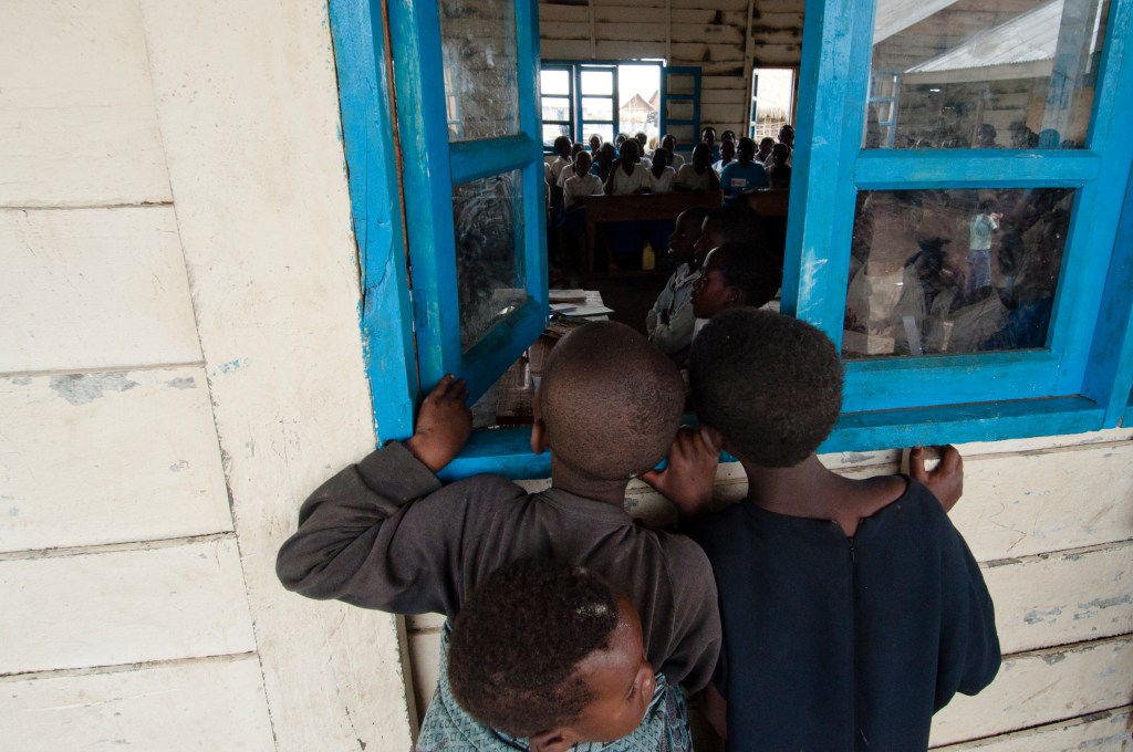 Boys looking into a schoolroom